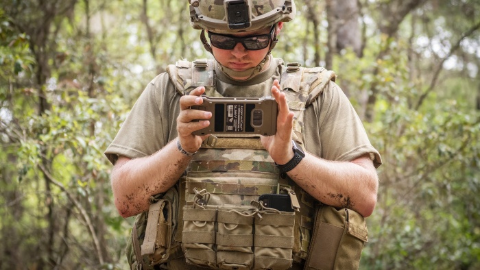 Person holding a tactical communication device