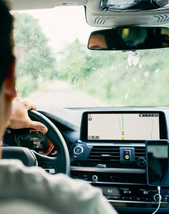 A driver behind the wheel using driver assist technology